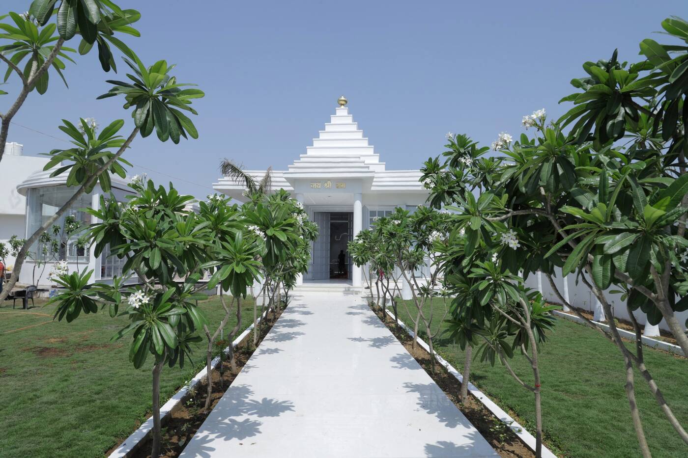 The tree-lined marble pathway leading to the temple
